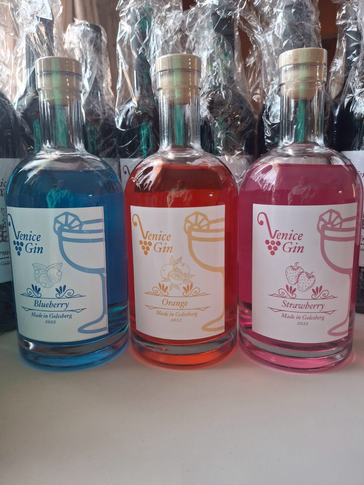 Venice Gin bottles in blueberry, orange and strawberry
